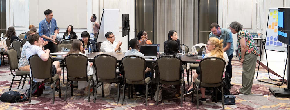 The session attendees around a table reflectiong and sharing about barriers and obstacles to engage to open science and research software development